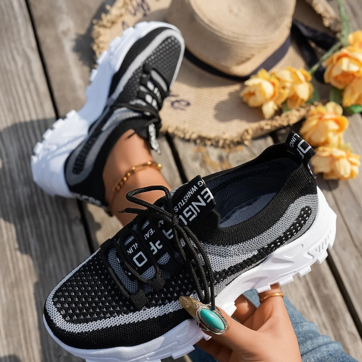 Women's Flyknit mesh lace-up sneaker in a grey colourway showing round toe and rubber sole.