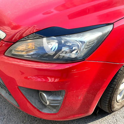 Ford Focus headlight eyebrow stickers in ABS plastic with carbon fibre pattern or piano black finish