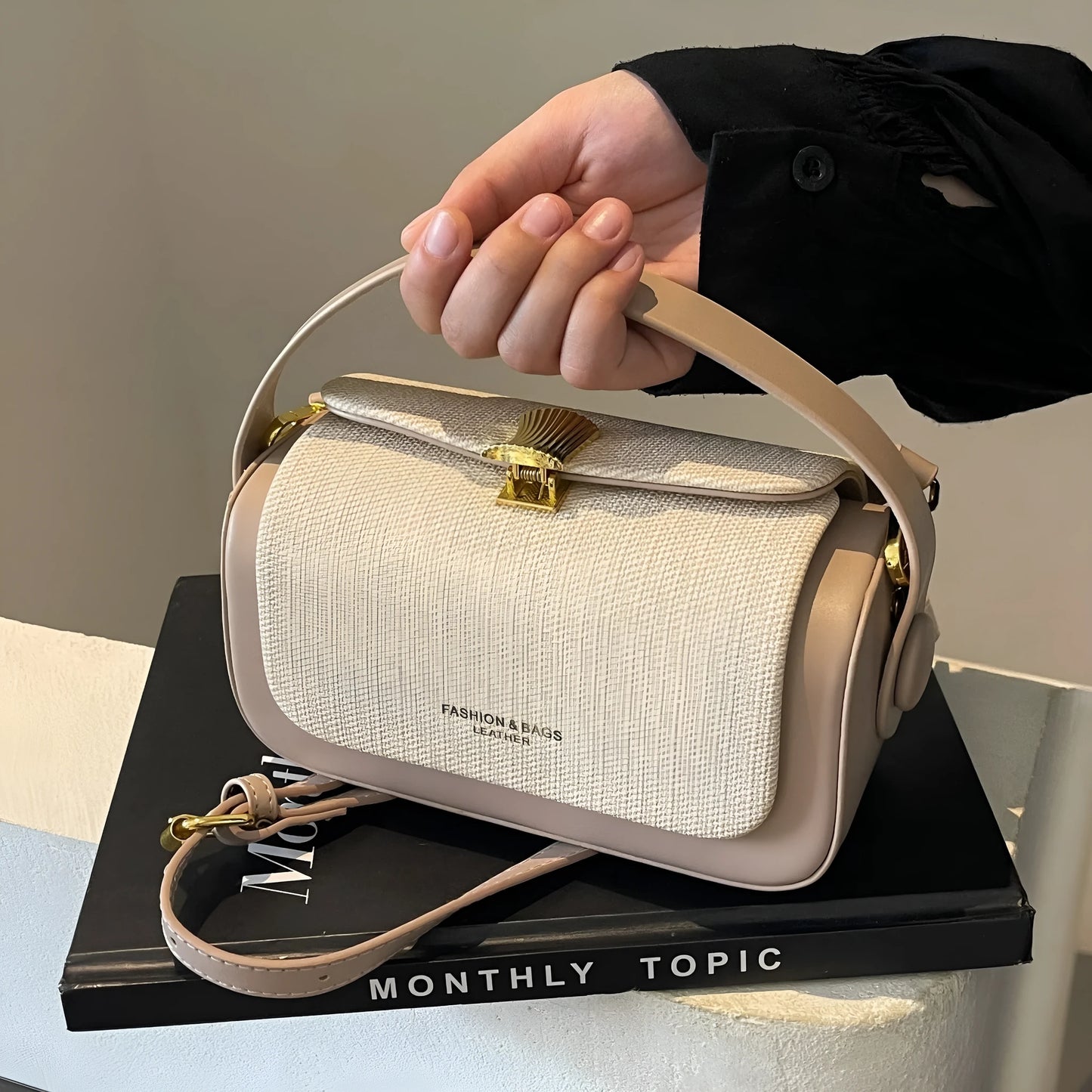 Women's PU leather messenger bag in a horizontal square shape with a lock and adjustable shoulder strap.