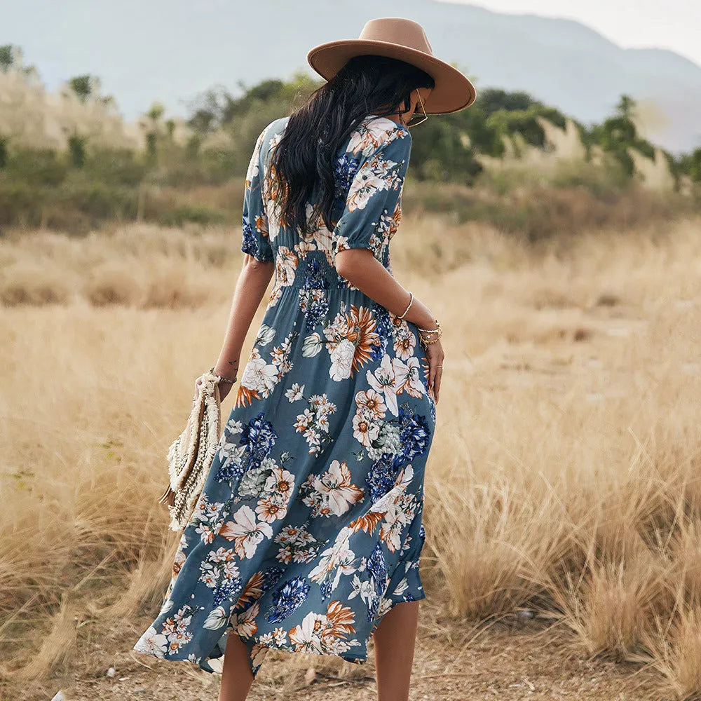 Floral summer beach dress with V-neck, elastic waist, and large hemline in mid-length design