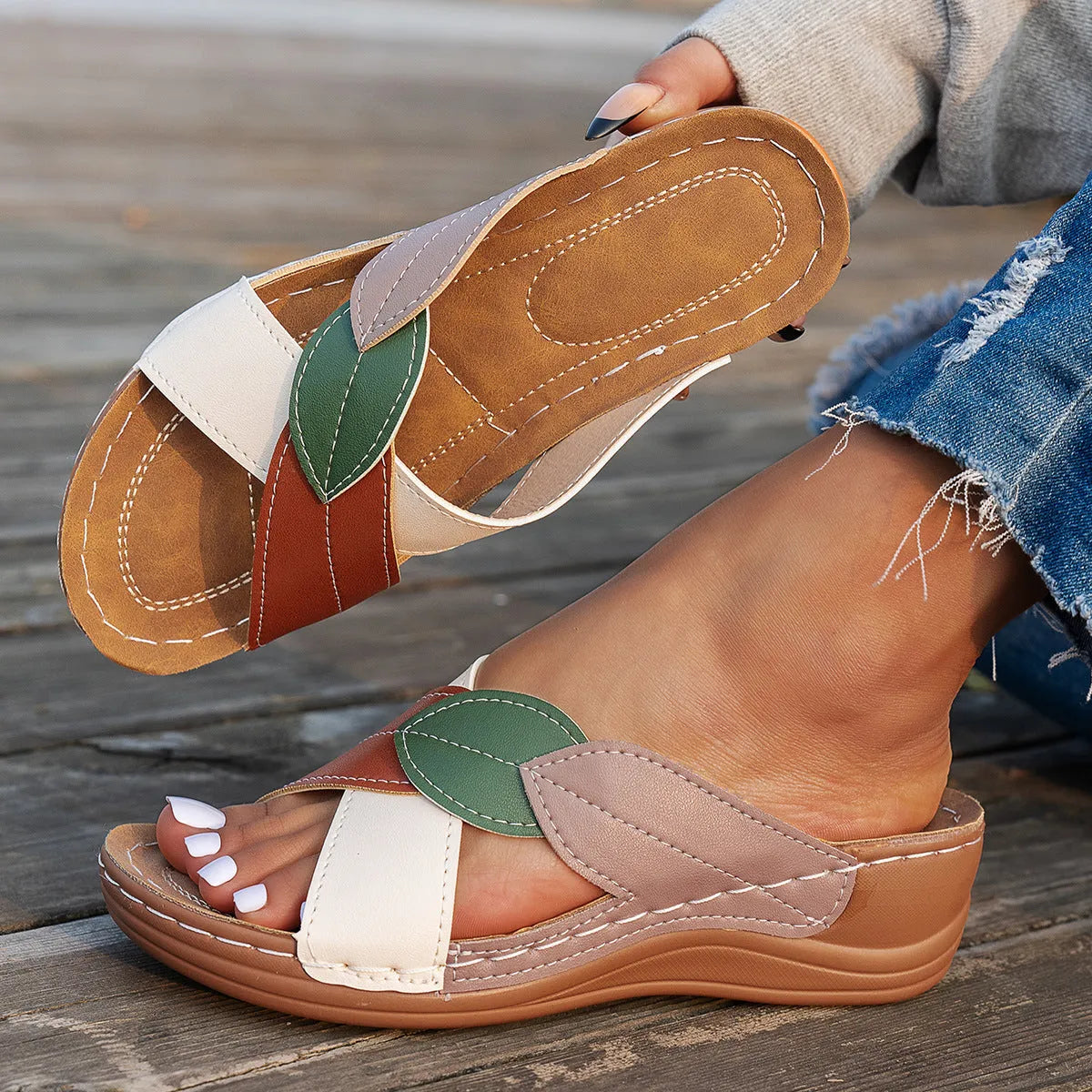 Women's black thick-soled cross-strap peep-toe slippers on a white background.