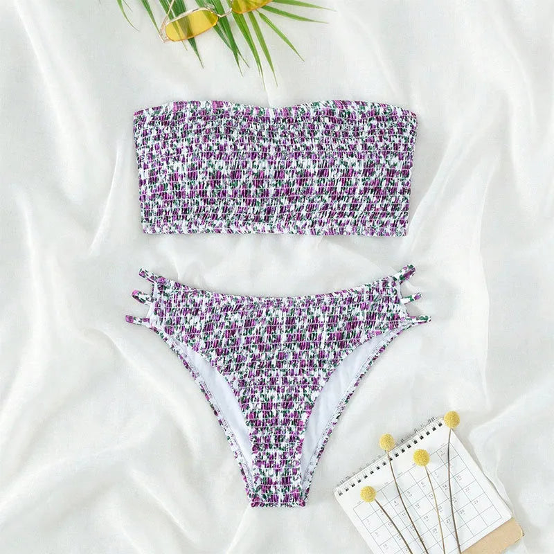 Women's strapless floral swimsuit with high-waist briefs and split back in green flower pattern.