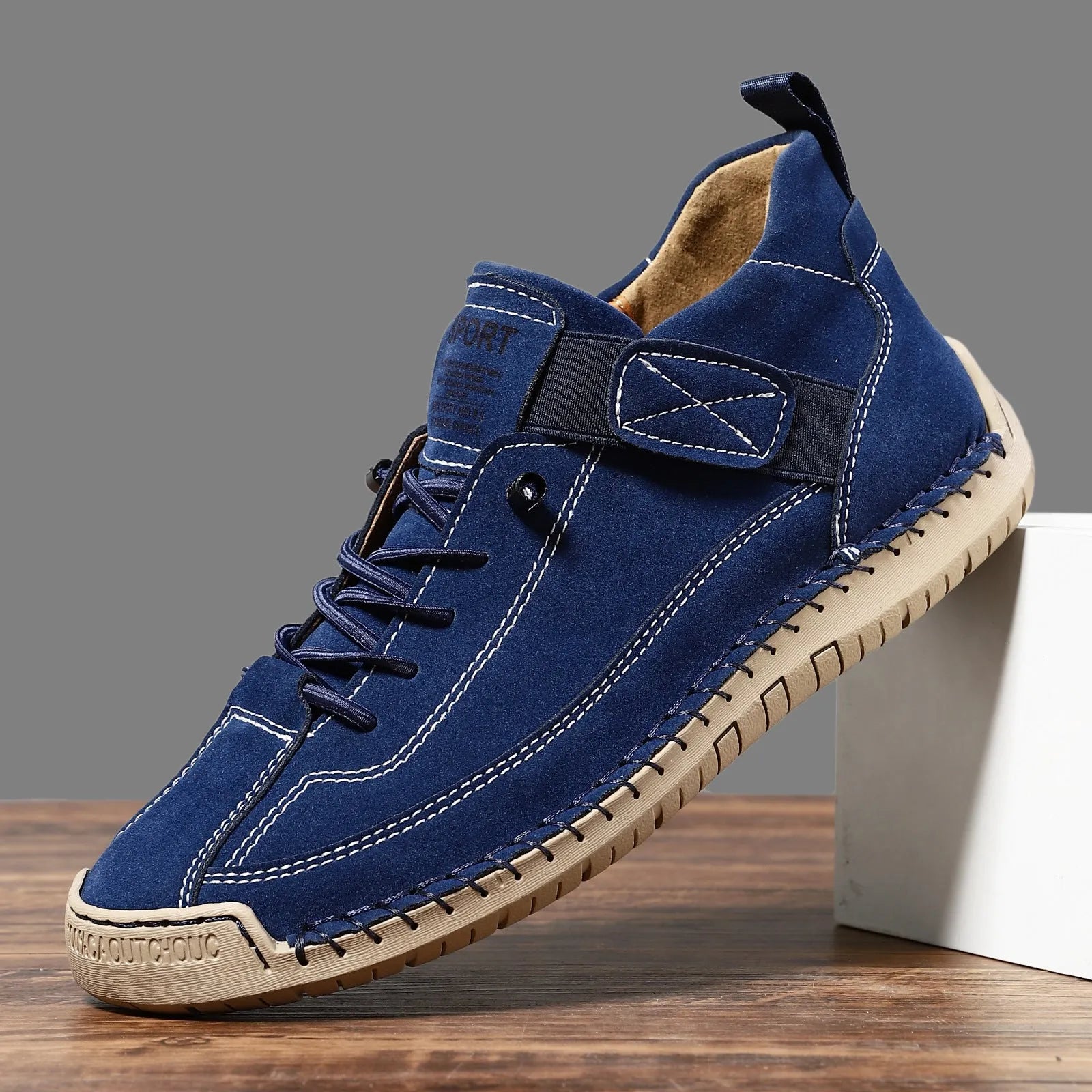 Men's black mid-top Martin boots with elastic band and sewn sole on a plain background.