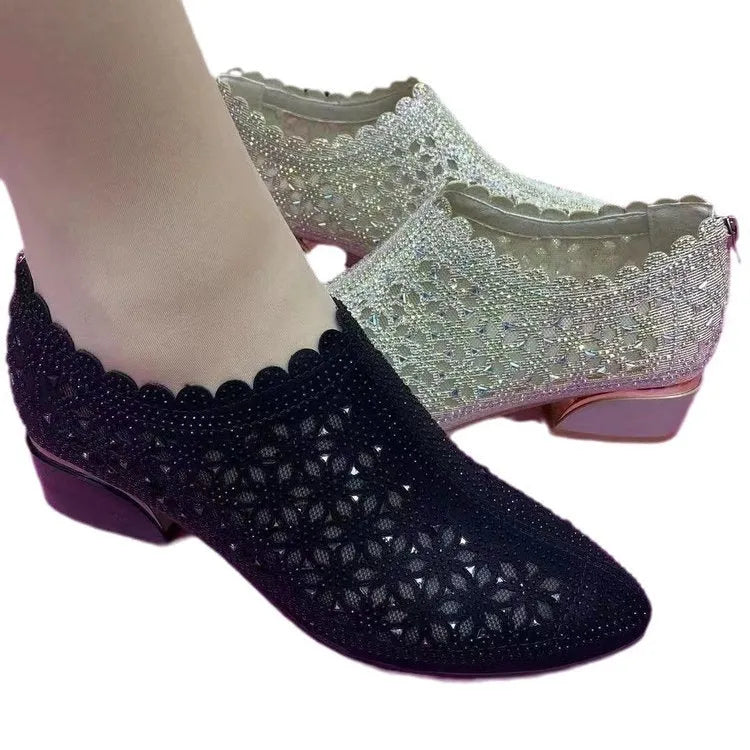 Women's chunky heel shoes with hollow-out upper, frosted full diamond detailing, round toe, canvas upper, and rubber sole.