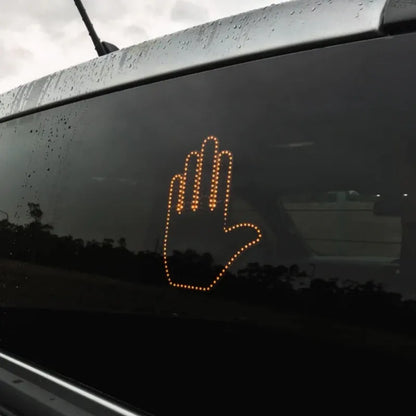 Black plastic LED gesture car light showing illuminated hand symbol, with remote control.
