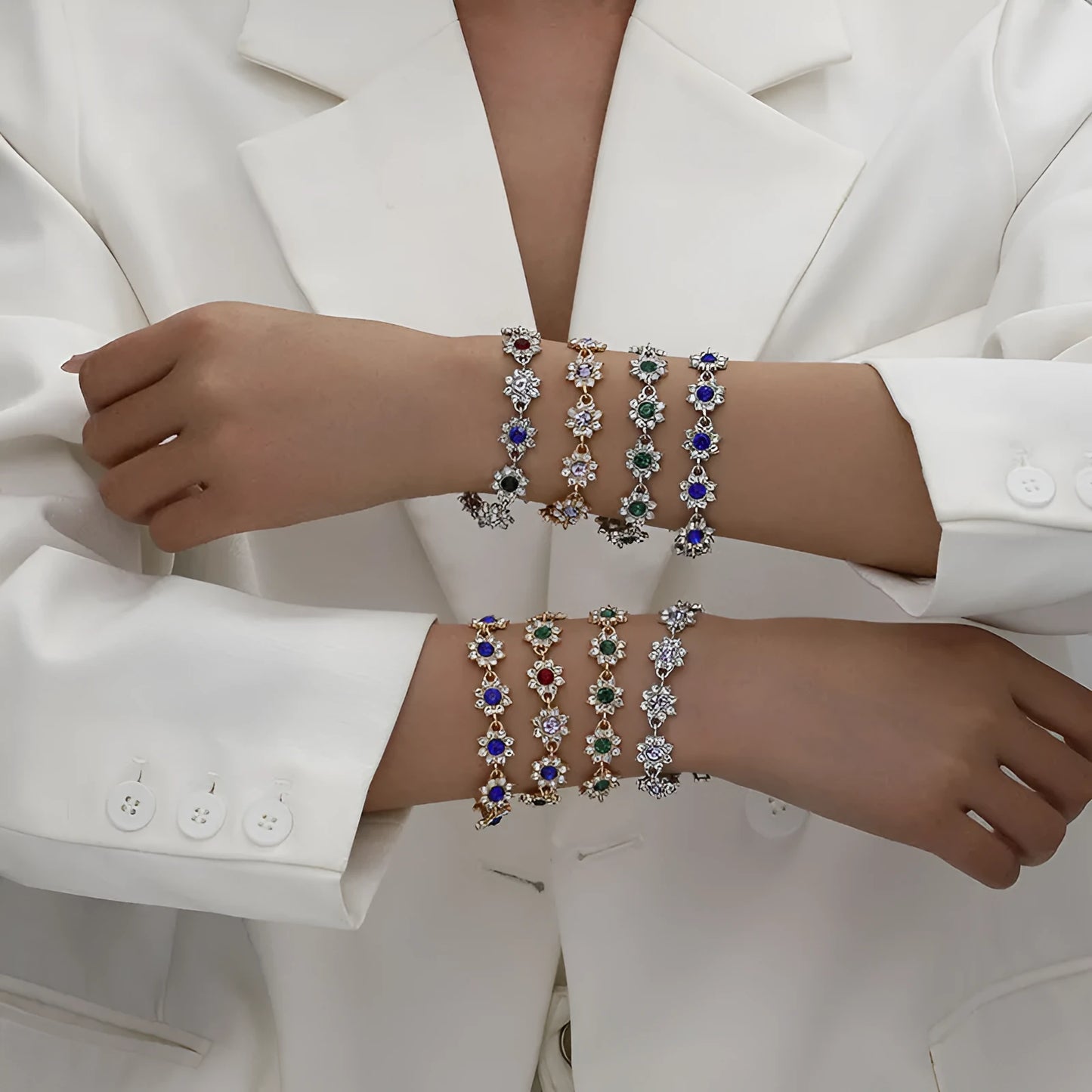 Gold and silver electroplated bracelets with flower charms set with coloured gemstones.