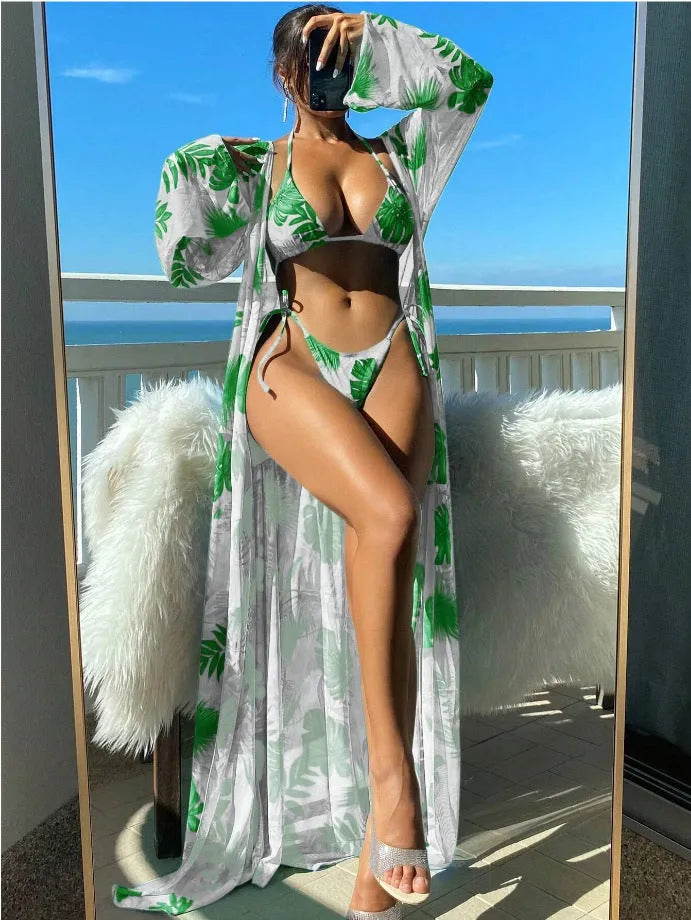 Polyester banded bikini set with long sleeve blouse, briefs, and robe cover-up in floral pattern