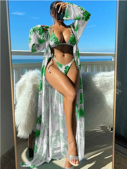 Polyester banded bikini set with long sleeve blouse, briefs, and robe cover-up in floral pattern