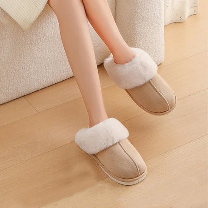 Women's plush winter slippers with round toe, flat heel, and stitching detail on a non-slip PVC sole.