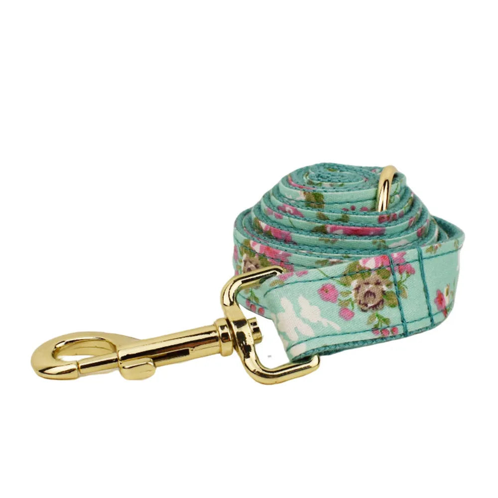 Rose and green cloth dog collar set with detachable bow, matching leash, and vest