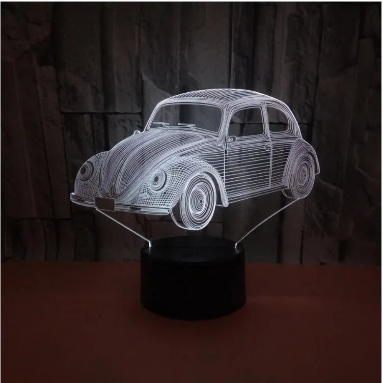 Colourful 3D LED table lamp with remote control and USB cable on wooden desk