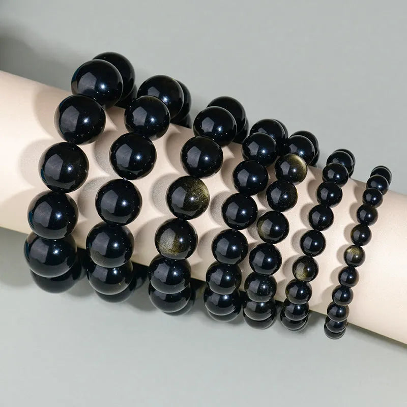 Hand-woven obsidian crystal bracelet showing round beads with ethnic styling in multiple colour options