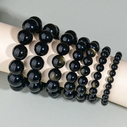 Hand-woven obsidian crystal bracelet showing round beads with ethnic styling in multiple colour options