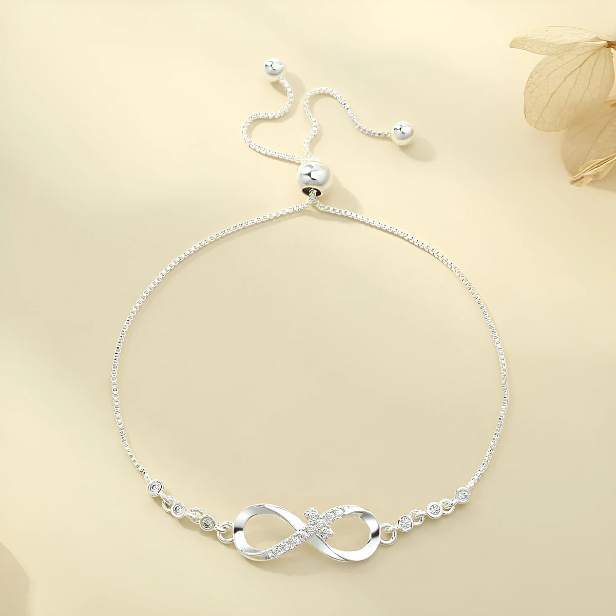 Diamond studded pull-out bracelet with infinite 8-shaped design, copper plastic, 26cm circumference, 20.0mm x 8.0mm