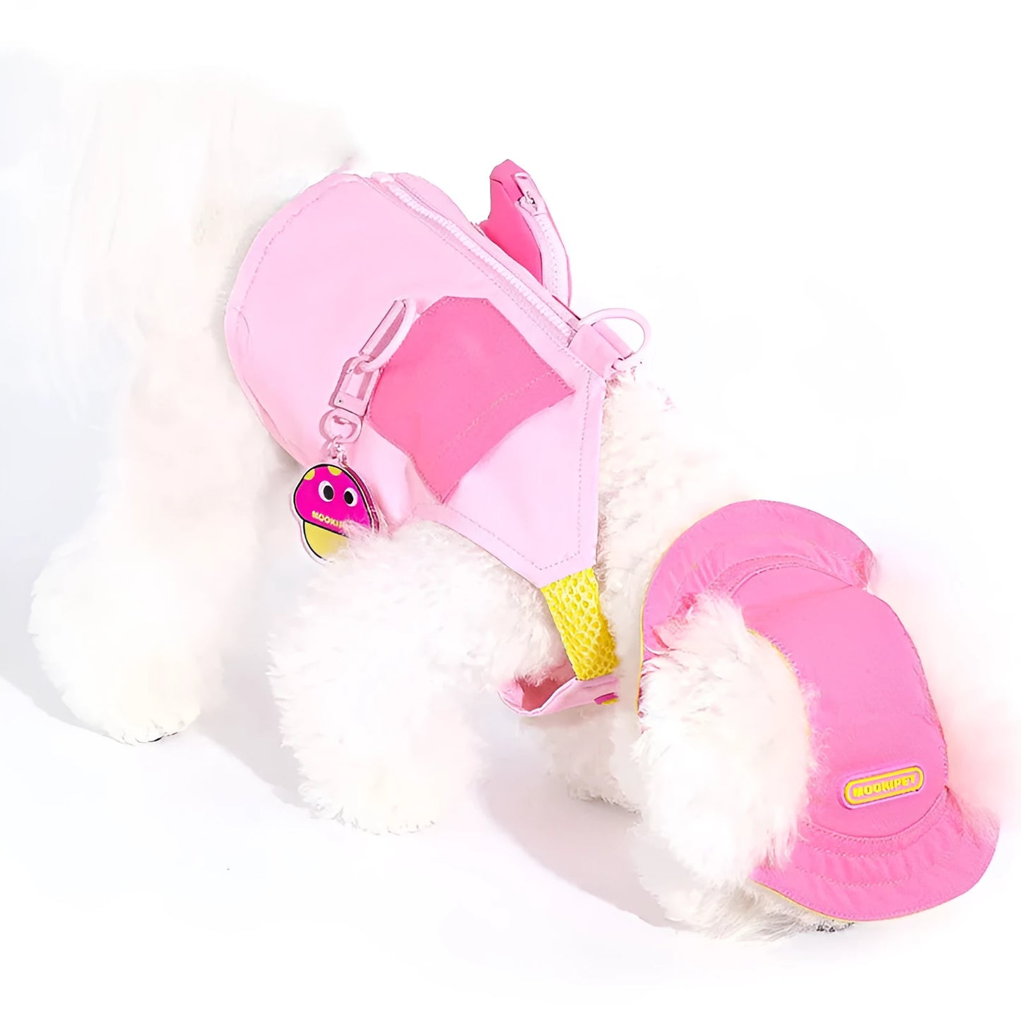 Pink polyester dog vest harness on a small white dog, showing back traction loop and casual fit.