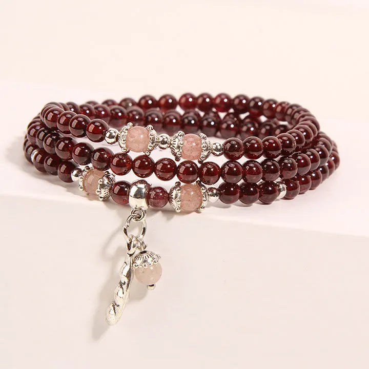 Women's crystal floral bracelet with wine red garnet stones and sauteed green beans detailing