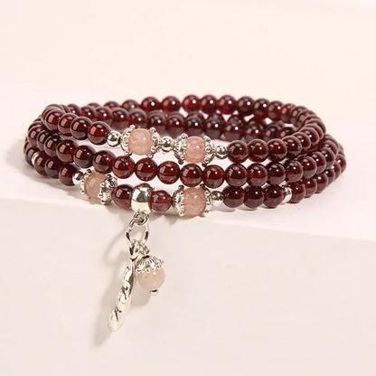 Women's crystal floral bracelet with wine red garnet stones and sauteed green beans detailing