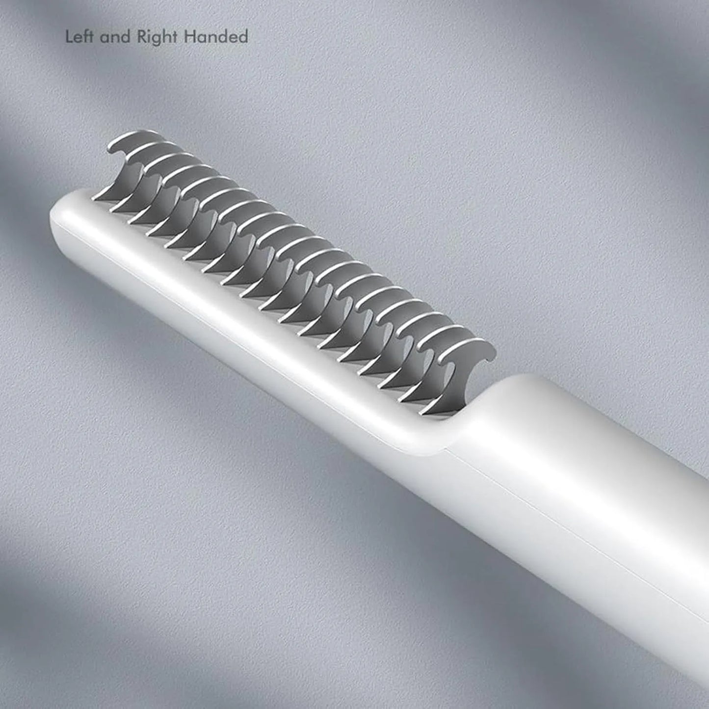 Pink and white stainless steel dematting comb for dogs on a plain background.