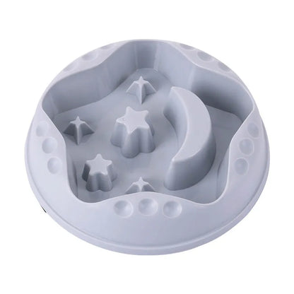 Blue slow feeder dog bowl with raised moon and star patterns inside, non-slip base