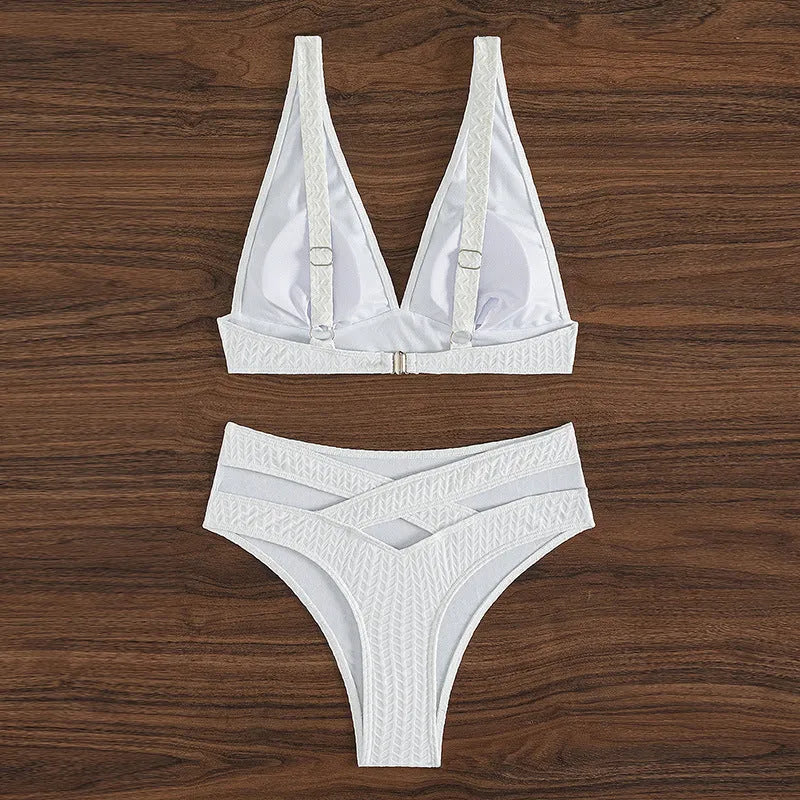 White women's backless bikini swimsuit with brief cut, laid flat showing bra and panties.