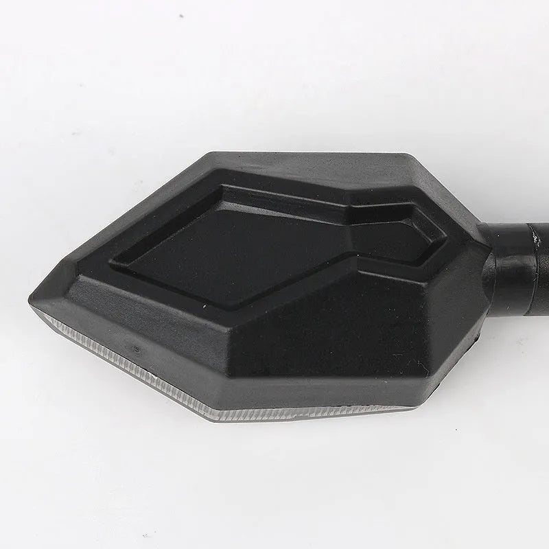 Arrow-shaped LED motorcycle directional turn signal light for 12V systems.