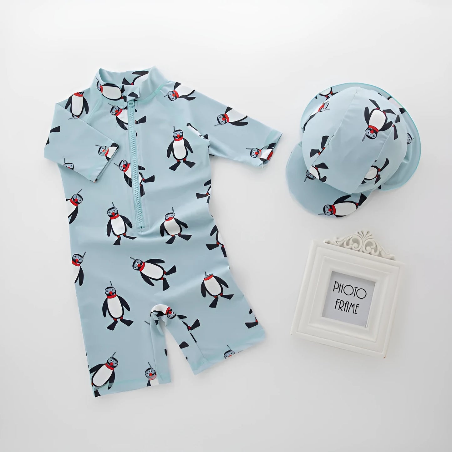 Boy's penguin-print long sleeve swimsuit with matching swimming cap for sun protection