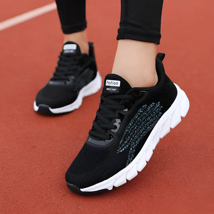 Women's black and white low-top casual running sneakers with round toe and MD soles
