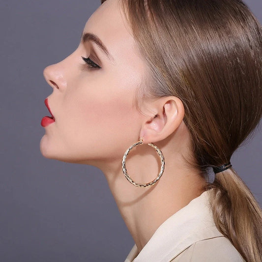Elegant geometric copper earrings with 18-carat gold plating, featuring a minimalist elliptical design