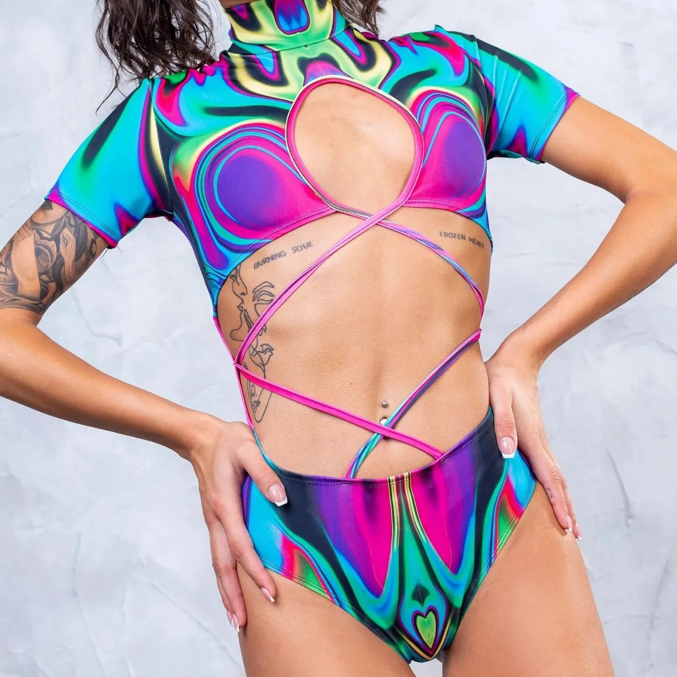 Patterned women's one-piece swimsuit with high turtleneck collar and long sleeves on a mannequin.