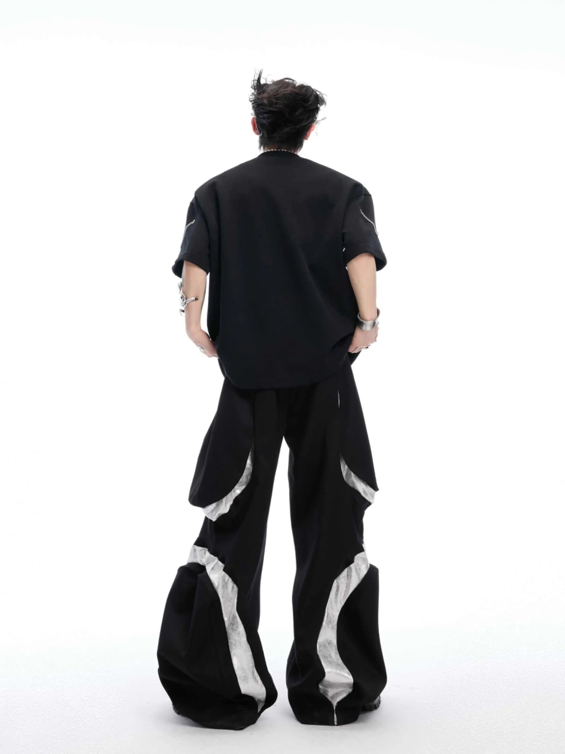 Black men's t-shirt with metal chain and padded shoulder detail on a short sleeve cotton-polyester blend.