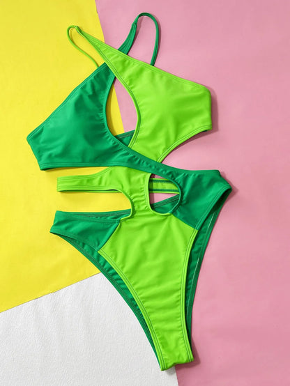 Green women's one-piece swimsuit with hollow contrast detail, made from nylon fabric.