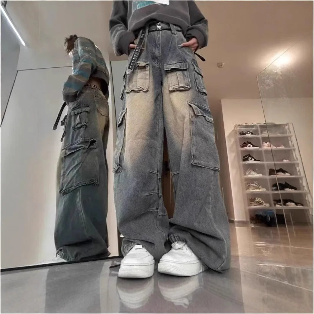 Men's loose straight-leg distressed jeans with multiple tooling pockets in light blue denim