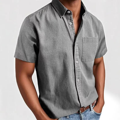 Man wearing a grey loose-fit short sleeve cardigan style shirt