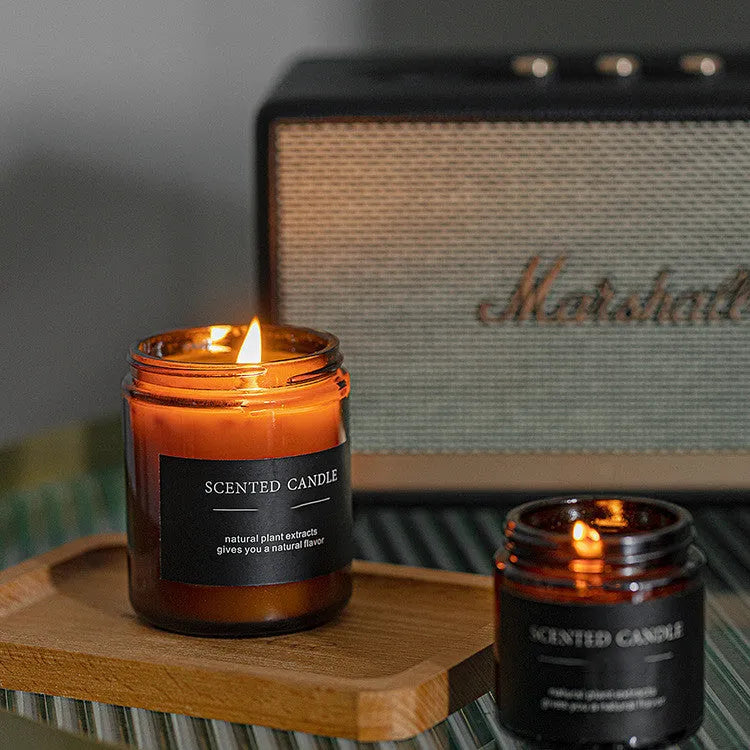 Brown glass bottle containing a hand-poured scented candle with a choice of sunny rose, lavender thyme, or bayberry fragrance.