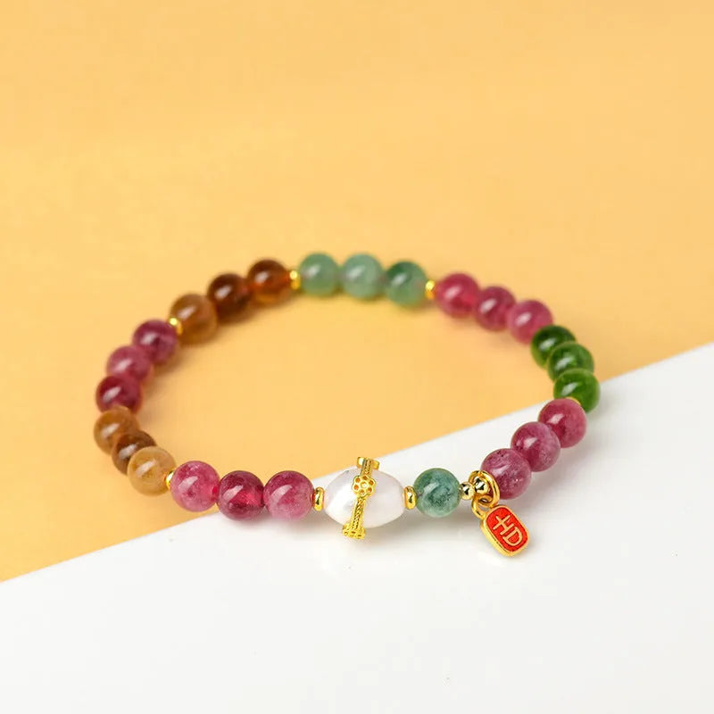 Chalcedony and tourmaline geometric bracelet with 6.5mm beads on a wrist.