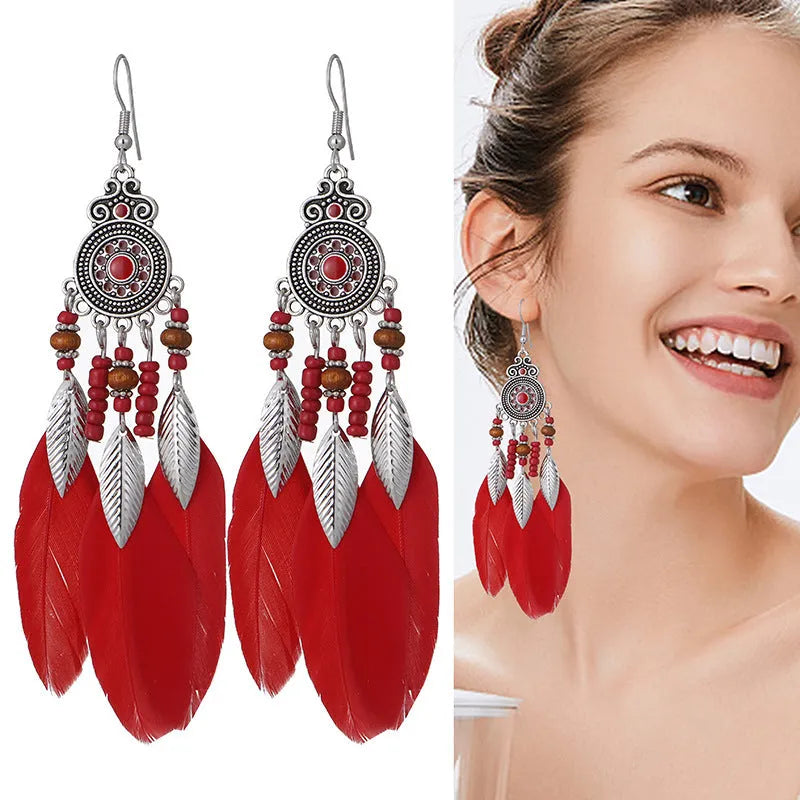 Round drop feather earrings in a bohemian leaf shape with patterned detail, shown in a light pink electroplated colour.