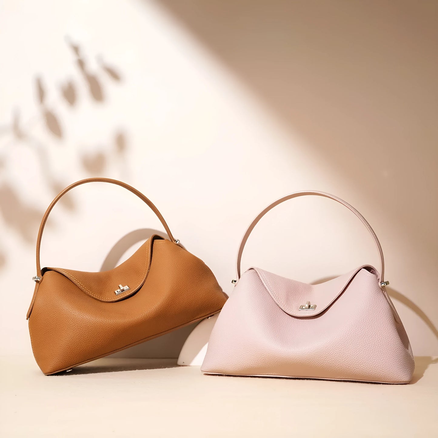 Cowhide leather shoulder messenger bag in a pillow shape with an open pocket and adjustable double straps.