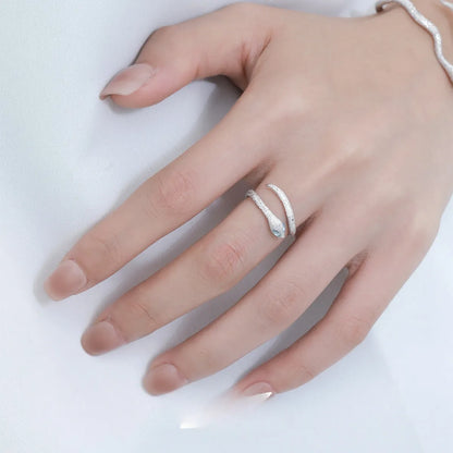 Platinum colour adjustable snake design ring for women on a neutral background.