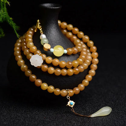 Women's green pine bead bracelet with jade leaves and sequin details on wrist