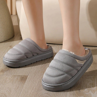 Cozy plush slip-on slippers in various colors, featuring a soft suede-like upper and a supportive EVA sole for maximum comfort and warmth.