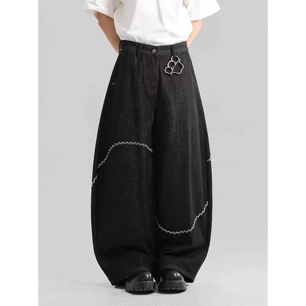 Men's black straight-leg denim trousers on a hanger, showing mid waist and zip fly detail.