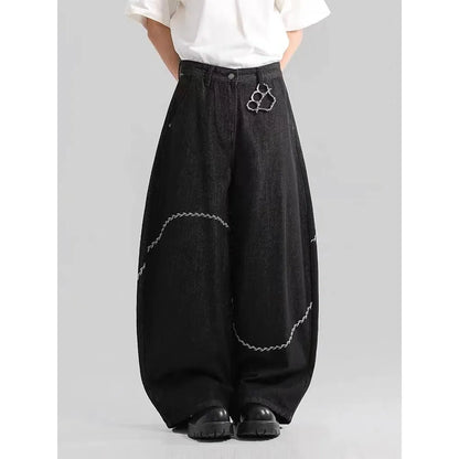Men's black straight-leg denim trousers on a hanger, showing mid waist and zip fly detail.