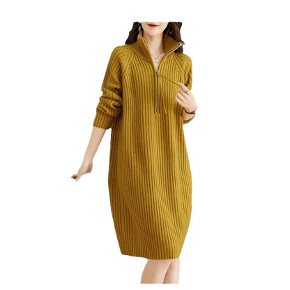 Beige half-zip woolen skirt with long sleeves, a stand collar, and a loose, straight midi silhouette.