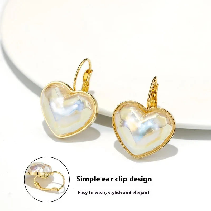 Gold-coloured alloy clip-on earring for women with a natural design.
