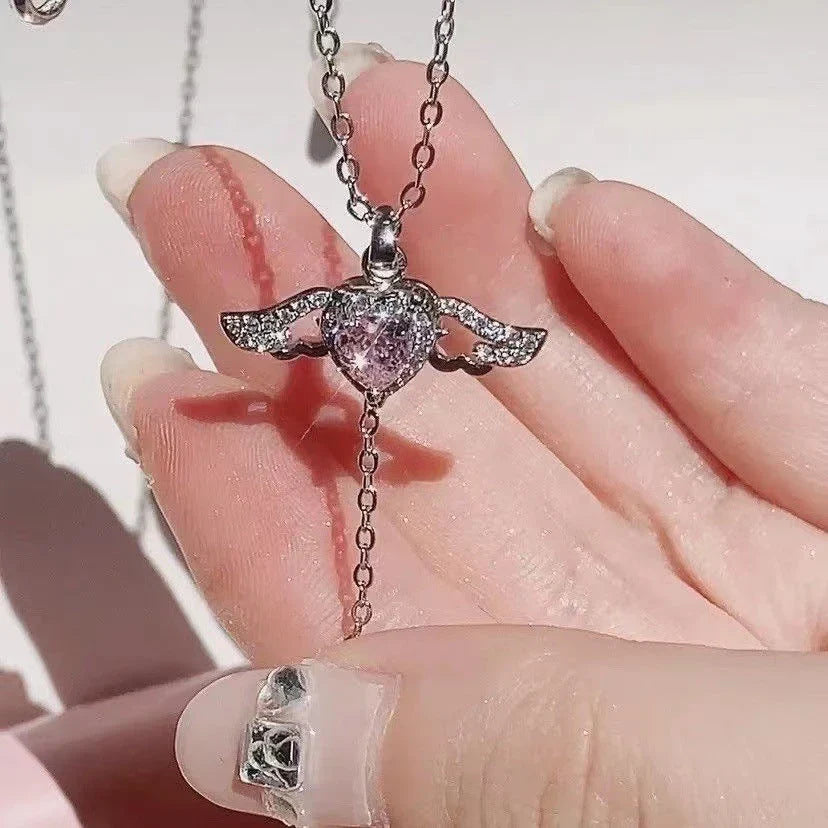 Elegant angel wings necklace with moving heart pendant, made of titanium steel and crystal accents