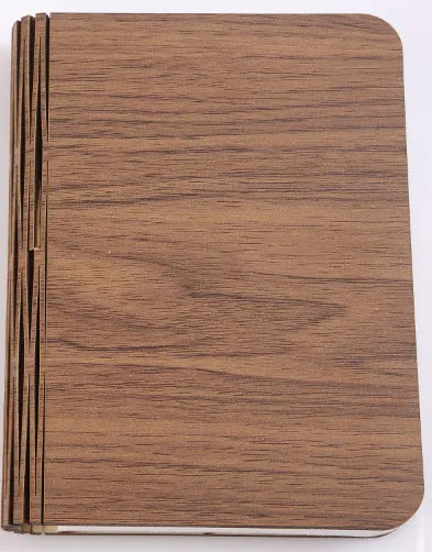 Modern wooden boy-shaped LED night light lamp on a surface in maple white, hu red, or hu black colour.