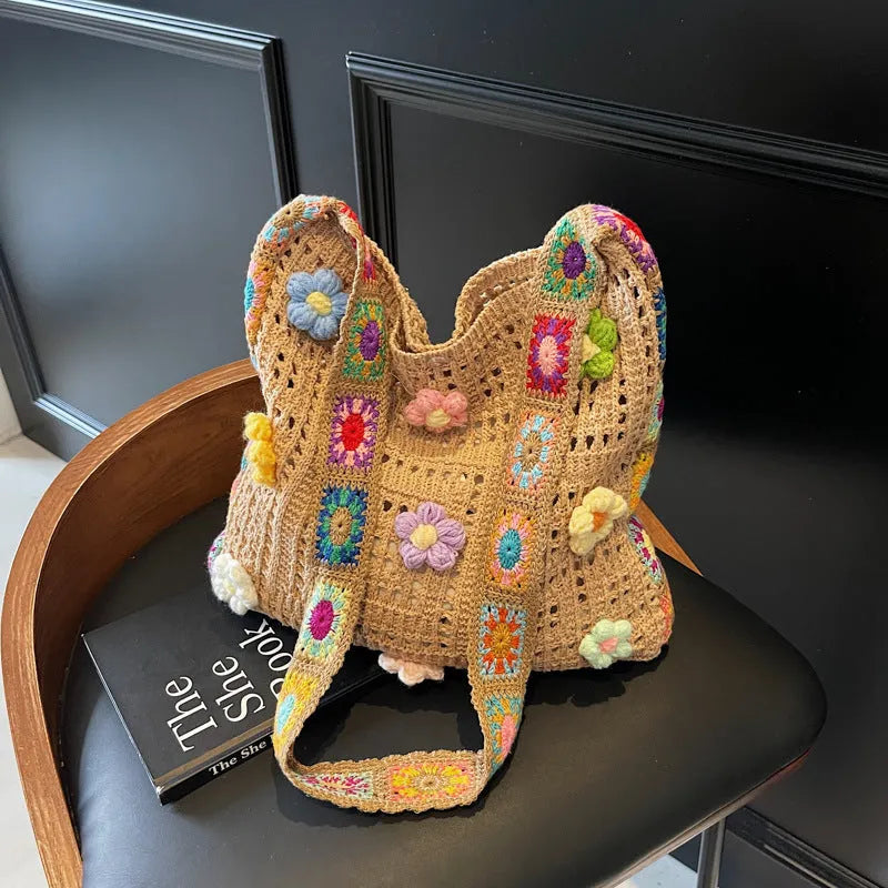 Women's large white knitted shoulder bag with hollow weave pattern and single strap.