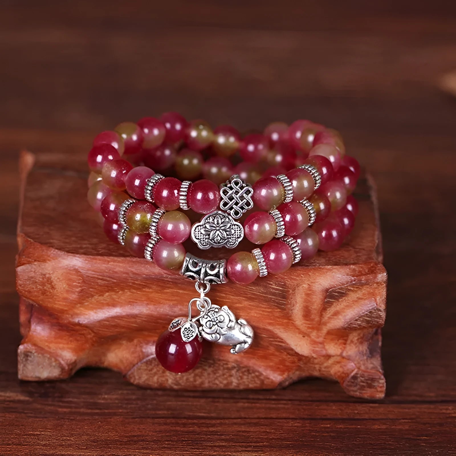 Handmade bracelet with green and pink watermelon crystal beads tied with Chinese knots.