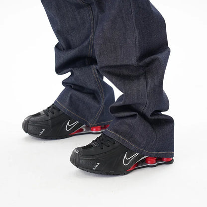 Men's dark blue loose straight-leg denim jeans laid flat, showing front view.