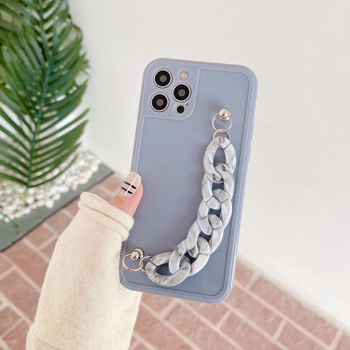 Marble pattern silicone phone case for iPhone with attached TPU bracelet, shown in grey blue colour.